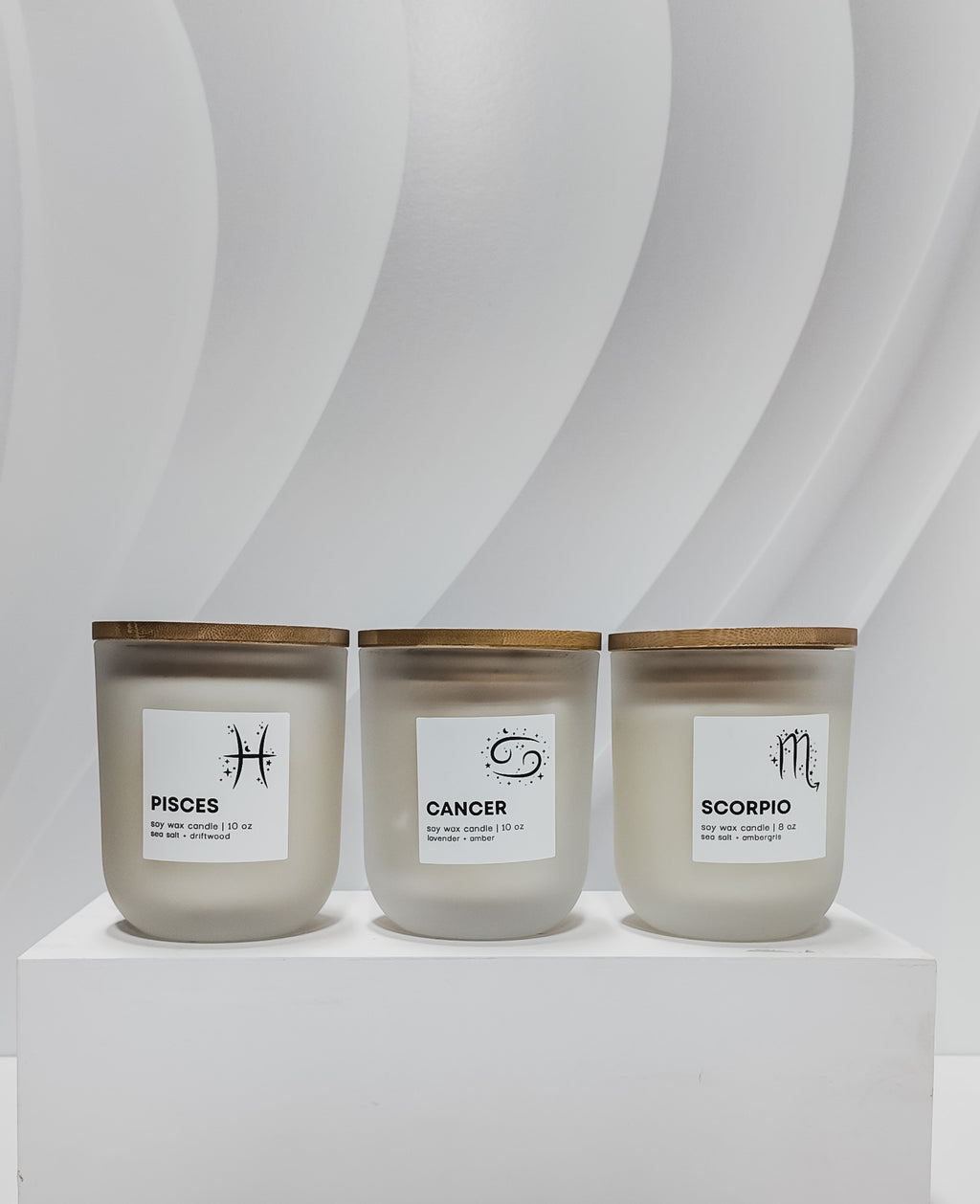 Candle labeled 'Cancer' on a white pedestal with a white background